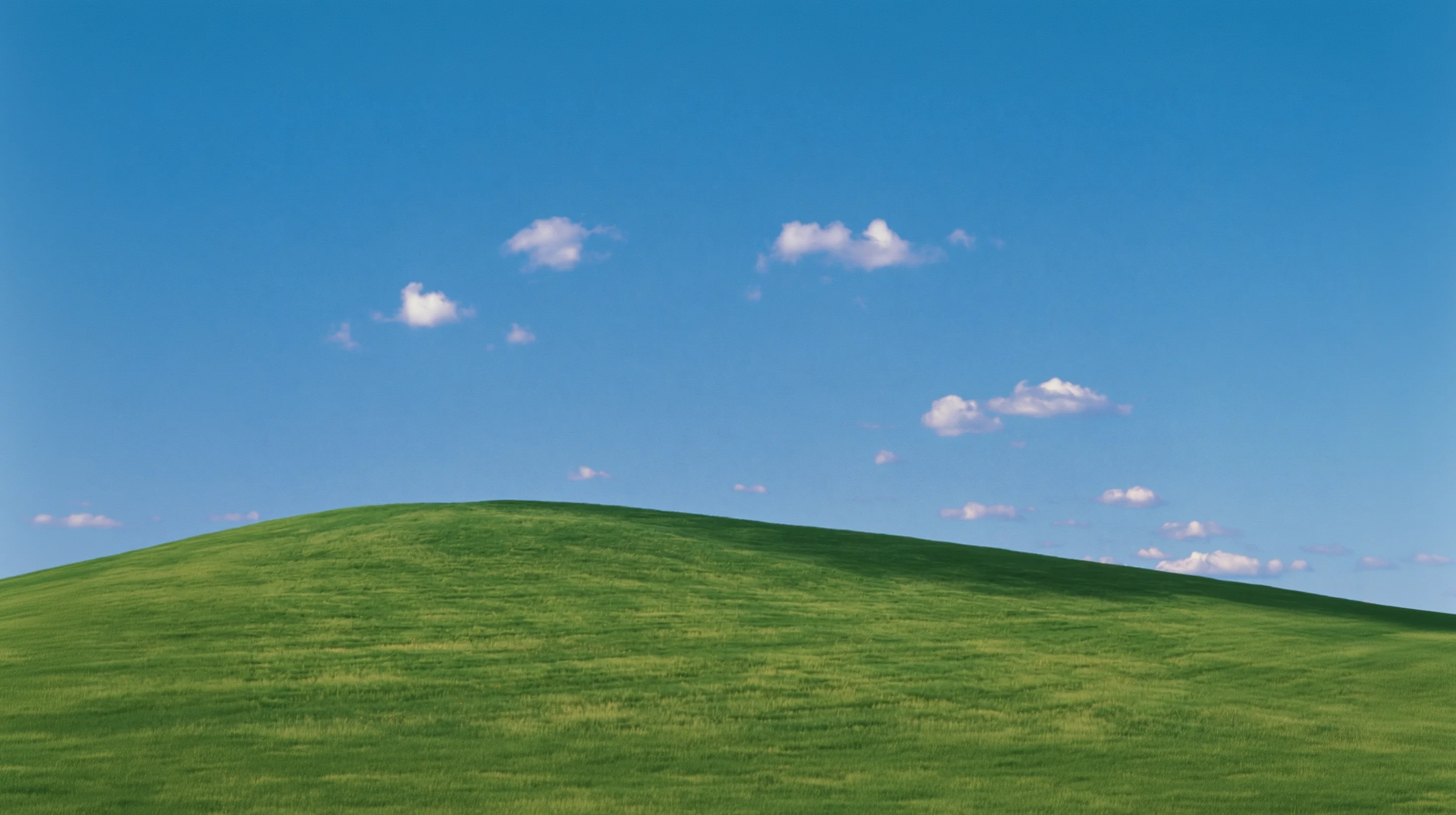 Rolling green hills under a clear blue sky